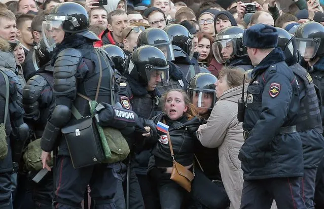 Russian riot policemen detain a demonstrator during an opposition rally in central Moscow, Russia, 26 March 2017. Russian opposition leader Alexei Navalny called on his supporters to join a demonstration in central Moscow despite a ban from Moscow authorities. Throughout Russia the opposition held the so-called anti-corruption rallies. According to reports, dozens of demonstrators have been detained across the country as they called for the resignation of Russian Prime Minister Dmitry Medvedev over corruption allegations. (Photo by Maxim Shipenkov/EPA)