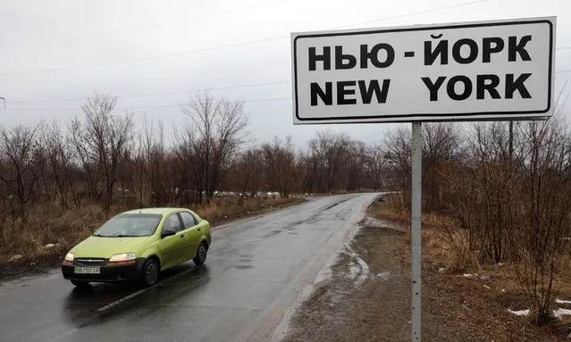 A road sign with name of small city New York, pictured not far from a front line near pro-Russian militants controlled city of Donetsk, Ukraine, 12 February 2022. Since 2014 locals adapted to live close to the front line what bring some restrictions to their life. The settlement first appeared on maps in 1846 under its original name New York. In 1951 was renamed to Novgorodskoye due to the worsening of relations of USSR with USA was. In July of 2021 Ukrainian Parliament returned it's old name New York. (Photo by Stanislav Kozliuk/EPA/EFE)