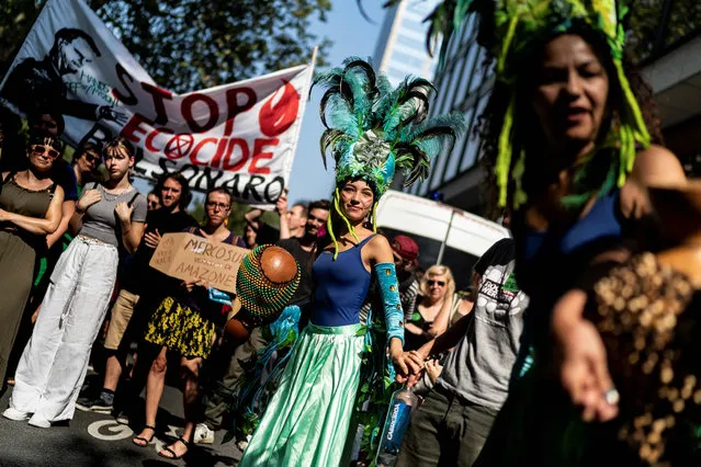 Protester dance as they gather in front of the Brazilan Embassy during a demonstration organised by Extinction Rebellion activists in Brussels, August 26, 2019, calling on Brazil to act to protect the Amazon rainforest from deforestation and fire. The Amazon rainforest has seen a record number of wildfires this year, which have triggered a global outcry. (Photo by Kenzo Tribouillard/AFP Photo)