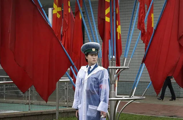 A North Korean traffic police woman stands in front of Workers' Party flags decorating the streets on Friday, May 6, 2016, in Pyongyang, North Korea. (Photo by Wong Maye-E/AP Photo)