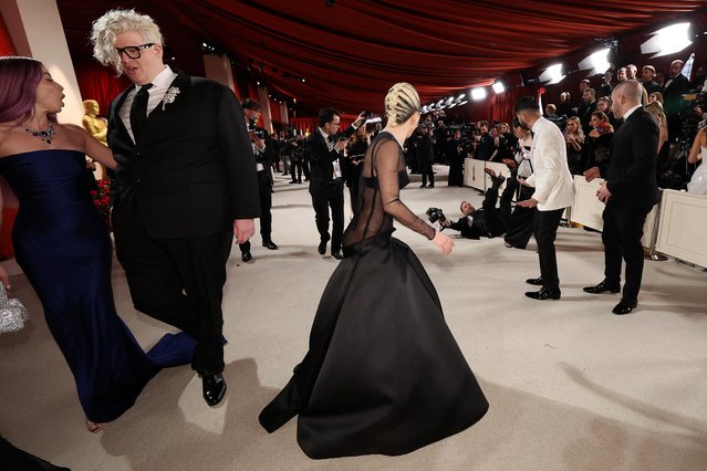 American singer-songwriter Lady Gaga and American musician BloodPop react on the champagne-colored red carpet during the Oscars arrivals at the 95th Academy Awards in Hollywood, Los Angeles, California, U.S., March 12, 2023. (Photo by Mario Anzuoni/Reuters)