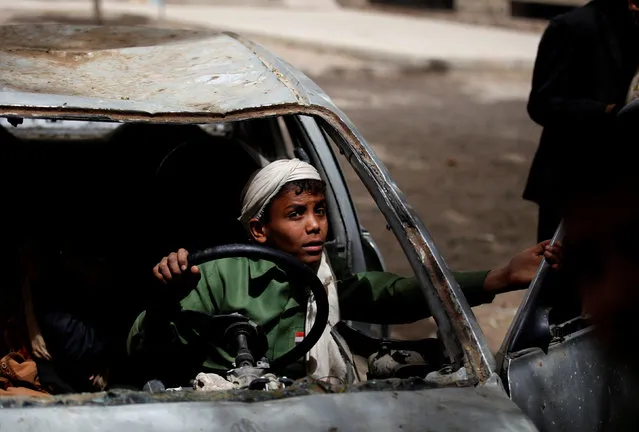Boys play in an abandoned car in the yard of The al-Shawkani Foundation for Orphans Care in Sanaa, Yemen, February 18, 2017. (Photo by Khaled Abdullah/Reuters)