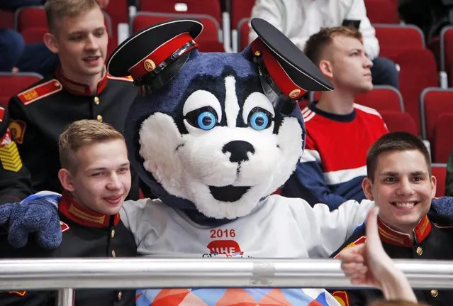 A mascot of Championships Laika sits among cadets during the Hockey World Championships Group B match between France and Belarus in St.Petersburg, Russia, Tuesday, May 17, 2016. (Photo by Dmitri Lovetsky/AP Photo)