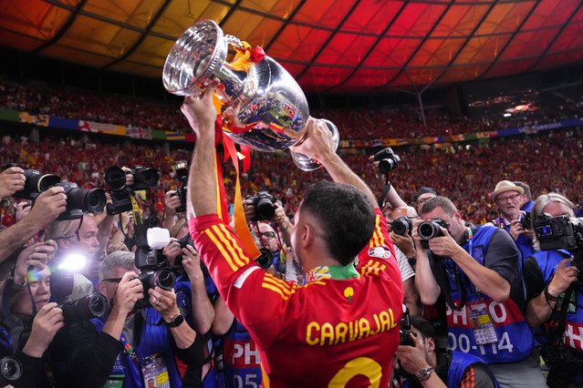 Spain's Dani Carvajal holds up the trophy to the fans after winning the final match between Spain and England at the Euro 2024 soccer tournament in Berlin, Germany, Sunday, July 14, 2024. Spain won 2-1. (Photo by Manu Fernandez/AP Photo)