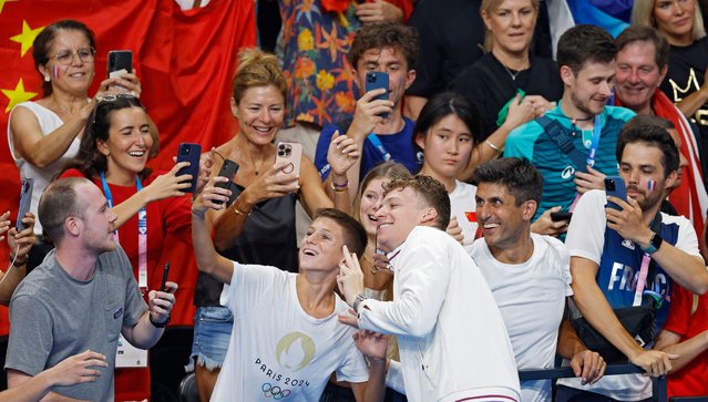 Gold medallist Leon Marchand of France poses for photos after the Men 200m Breaststroke final of the Swimming competitions in the Paris 2024 Olympic Games, at the Paris La Defense Arena in Paris, France, 31 July 2024. (Photo by Franck Robichon/EPA/EFE)