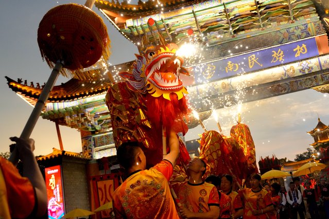 Folk artists perform fire dragon dance to celebrate the Torch Festival at Yunnan Ethnic Village on July 28, 2024 in Kunming, Yunnan Province of China. The Torch Festival is one of the most important traditional festivals celebrated by several ethnic groups in Yunnan Province. (Photo by Liu Ranyang/China News Service/VCG via Getty Images)