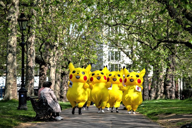 In this handout provided by No Coal Japan Coalition, protesters from No Coal Japan Coalition dress as Pokemon character Pikachu as they demonstrate outside the Japanese Embassy calling for Japan to end fossil fuel use by 2030 on May 18, 2023 in London, England. (Photo by Chris Ratcliffe for No Coal Japan Coalition via Getty Images)