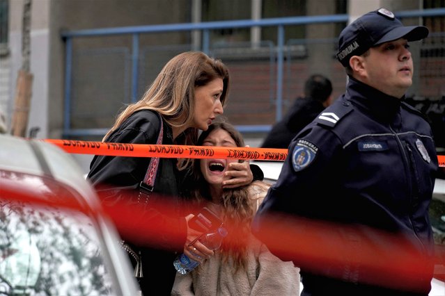 A parent escorts her child following a shooting at a school in the capital Belgrade on May 3, 2023. Serbian police arrested a student following a shooting at an elementary school in the capital Belgrade on May 3, 2023, the interior ministry said. The shooting occurred at 8:40 am local time (06:40 GMT) at an elementary school in Belgrade's downtown Vracar district.  (Photo by Oliver Bunic/AFP Photo)