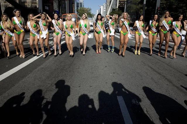 Miss BumBum Brazil contestants walk in the middle of Paulista Avenue to promote their beauty contest in the financial district of Sao Paulo, Brazil, Monday, August 3, 2015. The contest is set for November. (Photo by Andre Penner/AP Photo)