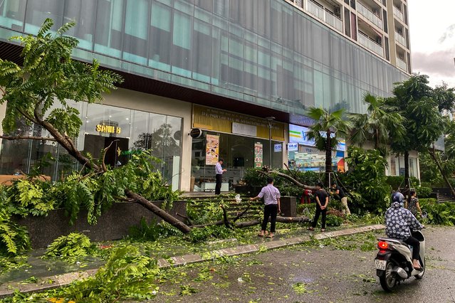 People stand near a devastated area following the impact of Typhoon Yagi, in Hanoi, Vietnam, on September 8, 2024. (Photo by Thinh Nguyen/Reuters)