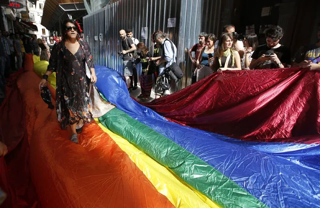 People gather to protest against the ban on the gay pride march, off Istiklal Avenue, central Istanbul's main shopping road, Sunday, June 19, 2016. Turkish police fired tear gas and rubber bullets to disperse demonstrators who gathered for a gay pride rally in Istanbul despite a government ban over security concerns. (Photo by Emrah Gurel/AP Photo)