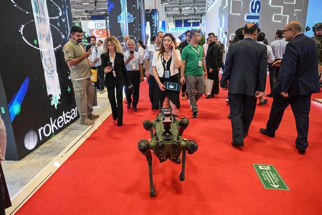 A robot is seen with visitors at the 16th International Defense Industry Fair 2023, one of the largest defense industry events in the world, at TUYAP Fair and Congress Center in Istanbul, Turkiye on July 28, 2023. (Photo by Anadolu Agency)