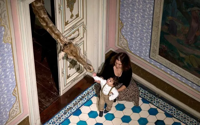 People pose with Anonymous “Head and Neck of Giraffe” taxidermy art work during “The Child Within Me” exhibition at the Abdulmecit Efendi mansion in Istanbul, Turkey, 14 November 2019. Since the opening of the 16th Istanbul Biennial on 20 September, the exhibition has been visited by approximately 100,000 people and has been extended until 29 December due to intense interest. (Photo by Erdem Sahin/EPA/EFE/Rex Features/Shutterstock)