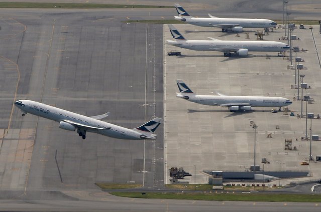 A Cathay Pacific Airways passenger flight takes off at Hong Kong Airport in Hong Kong, China in this June 12, 2015 file photo. Cathay Pacific Airways Ltd is expected to announce first half results this week. (Photo by Bobby Yip/Reuters)