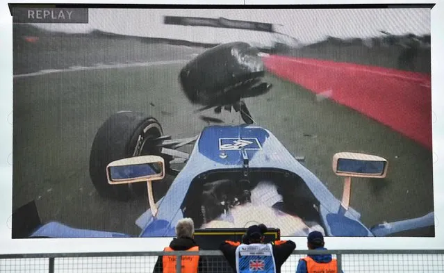 Stewards wach a giant screen displaying the moment that Sauber F1 Team's Swedish driver Marcus Ericsson crashed into the barrier during the third practice session during at Silverstone motor racing circuit in Silverstone, central England, on July 9, 2016, ahead of tomorrow's British Formula One Grand Prix. (Photo by Andrej Isakovic/AFP Photo)
