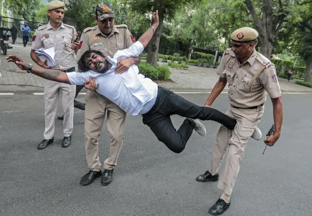 Security personnel detain an Indian National Congress (INC) activists during a protest at Congress head office in Delhi, India, 21 July 2022. INC workers protested as Enforcement Directorate (ED) summoned Sonia Gandhi to appear at the ED office in relation to the alleged misappropriation of assets of a newspaper “The National Herald”. (Photo by Rajat Gupta/EPA/EFE/Rex Features/Shutterstock)