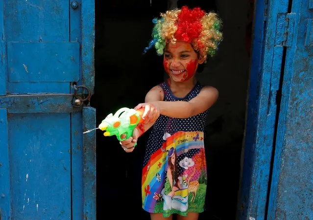 A girl plays with a water gun during Holi celebrations in Kolkata, India, March 9, 2020. (Photo by Rupak De Chowdhuri/Reuters)