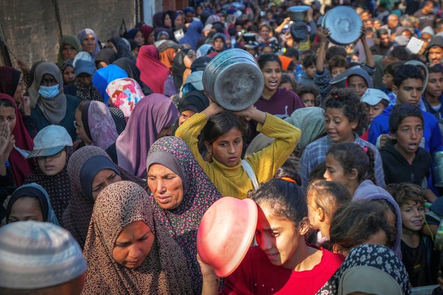 Palestinian children queue for donated food in Deir al-Balah, Gaza Strip, Friday November 22, 2024. (Photo by Abdel Kareem Hana/AP Photo)