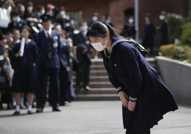 Japan's Princess Aiko, daughter of Emperor Naruhito and Empress Masako, wearing a protective face mask following an outbreak of the coronavirus disease (COVID-19), bows to well-wishers as she attends her graduation ceremony at Gakushuin Girls' Senior High School in Tokyo, Sunday, March 22, 2020. (Photo by Issei Kato/Pool Photo via AP Photo)