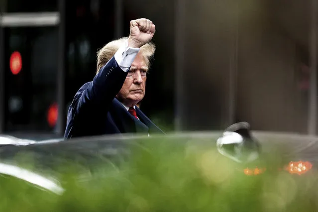 Former President Donald Trump gestures as he departs Trump Tower, Wednesday, August 10, 2022, in New York, on his way to the New York attorney general's office for a deposition in a civil investigation. (Photo by Julia Nikhinson/AP Photo)
