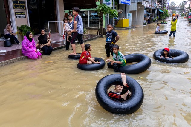 Children play on a flooded street in Hat Yai district, Songklha province, Thailand on November 30, 2024. (Photo by Roylee Suriyaworakul/Reuters)
