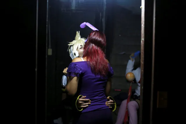 Participants kiss at the backstage during the Cuban Otaku festival in Havana, Cuba, July 24, 2016. (Photo by Alexandre Meneghini/Reuters)