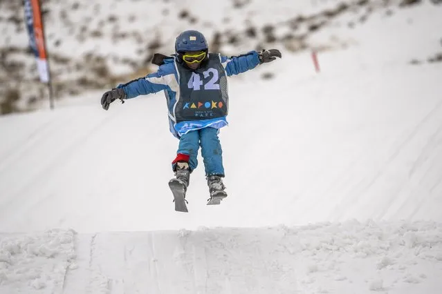 John Bokang competes in the youth category of the Winter Whip Slopestyle snowboard and ski competition at the Afriski ski resort near Butha-Buthe, Lesotho, Saturday July 30, 2022. While millions across Europe sweat through a summer of record-breaking heat, Afriski in the Maluti Mountains is Africa's only operating ski resort south of the equator. It draws people from neighboring South Africa and further afield by offering a unique experience to go skiing in southern Africa. (Photo by Jerome Delay/AP Photo)