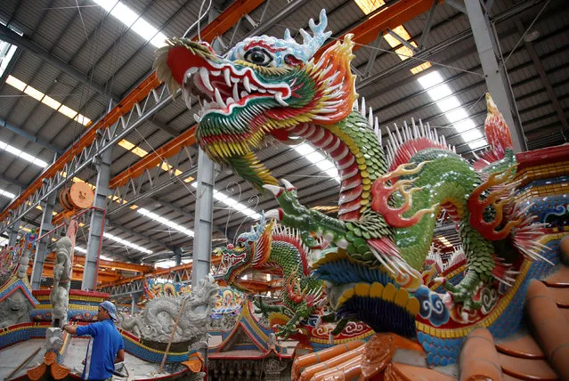 A dragon decoration is seen with a ready-made Chinese traditional temple at the Chuanso factory that manufactures religious objects in Pingtung, Taiwan July 5, 2016. (Photo by Tyrone Siu/Reuters)
