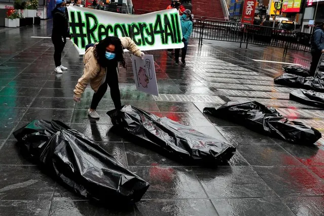 Demonstrators arrange props staged as body bags representing the death and despair in immigrant worker and essential worker communities during May Day protests in Manhattan, following the outbreak of the coronavirus disease (COVID-19) in New York City, New York, U.S., May 1, 2020. (Photo by Mike Segar/Reuters)