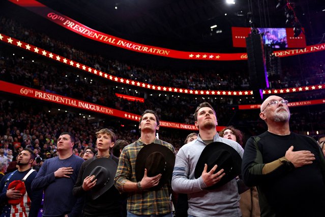 Attendees hold their hats during the national anthem on the inauguration day of Donald Trump's second presidential term, inside Capital One arena, in Washington on January 20, 2025. (Photo by Amanda Perobelli/Reuters)
