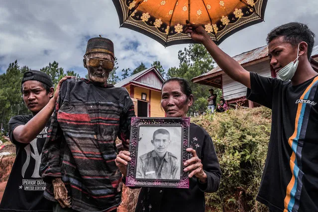 In this picture, a family presents Djim Sambara, who died two years ago when aged 90. Sambara was honourably buried in his military uniform before the family changed his outfit. (Photo by Claudio Sieber Photography/The Guardian)