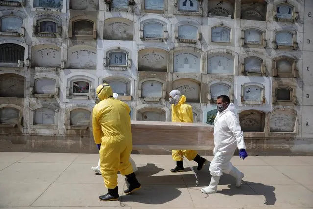 Funeral workers carry a coffin holding the body of a person who died of the coronavirus disease (COVID-19), at a cemetery in Lima, Peru, May 9, 2020. (Photo by Sebastian Castaneda/Reuters)