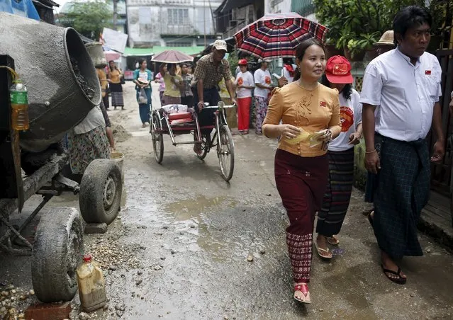 Khine Mar Htay (front L), a candidate from the National League for Democracy (NLD) party, walks down a road with her party members as they campaign for the upcoming Nov. 8 general election, in Yangon September 8, 2015. (Photo by Soe Zeya Tun/Reuters)