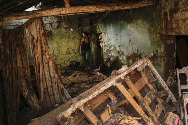 Erika Quintero stands in her home that was damaged after a landslide and flood ripped through Las Tejerias in Venezuela, Monday, October 10, 2022. The fatal landslide was fueled by days of torrential rain and floods that swept through this town in central Venezuela. (Photo by Matias Delacroix/AP Photo)