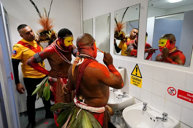 Papau New Guinea fans apply face paint in the toilets ahead of the Rugby League World Cup group D match at The Halliwell Jones Stadium, Warrington, UK on Tuesday, October 25, 2022. (Photo by Mike Egerton/PA Images via Getty Images)
