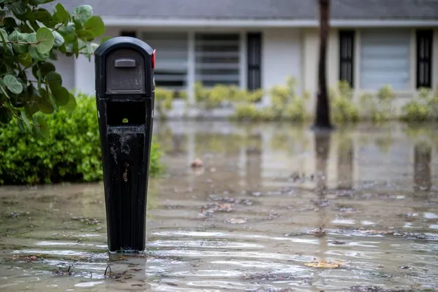A partially submerged mailbox is seen in front of a flooded house following the passage of Hurricane Nicole in Vero Beach, Florida, U.S. November 10, 2022. (Photo by Ricardo Arduengo/Reuters)