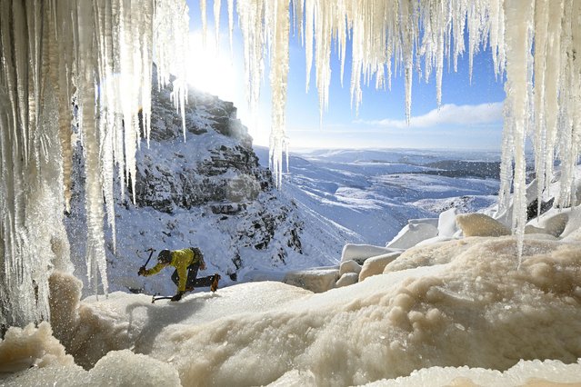 An ice climber ascends Kinder Downfall, a frozen waterfall in the Peak District National Park, near Hayfield, in north-west England as temperatures in the region plummet on January 10, 2025. Temperatures continue to fall over the coming days, possibly reaching minus 20C in northern parts of the UK on Friday night, the Met Office has forecast. (Photo by Oli Scarff/AFP Photo)