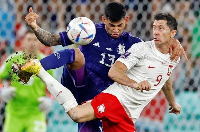 Robert Lewandowski of Poland in action against Cristian Romero (R) of Argentina during the FIFA World Cup Qatar 2022 Group C match between Poland and Argentina at Stadium 974 on November 30, 2022 in Doha, Qatar. (Photo by Amanda Perobelli/Reuters)