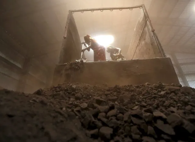 Workers unload coal from a supply truck at a yard on the outskirts of the western Indian city of Ahmedabad in this April 15, 2015 file photo. Coal futures are trading at $50 a tonne for the first time since 2003 as the commodity downturn deepens, and U.S. investment bank Goldman Sachs says the resource will never gain enough traction again to lift it out of its slump. (Photo by Amit Dave/Reuters)