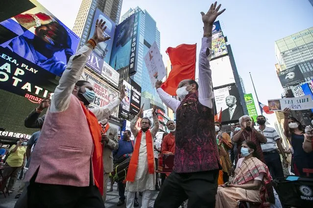 People gather in Times Square after the groundbreaking ceremony of a temple dedicated to the Hindu god Ram by Indian Prime Minister Narendra Modi, Wednesday, August 5, 2020, in New York. Hindus rejoiced as Modi broke ground on a long-awaited temple of their most revered god, Ram, at the site of a demolished 16th century mosque. (Photo by Frank Franklin II/AP Photo)