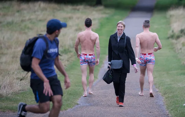The Naked Magicians, Christopher Wayne and Mike Tyler, commute through Hyde Park in London, England en route to their show at Trafalgar Studios on September 6, 2016. (Photo by Graeme Robertson/The Guardian)