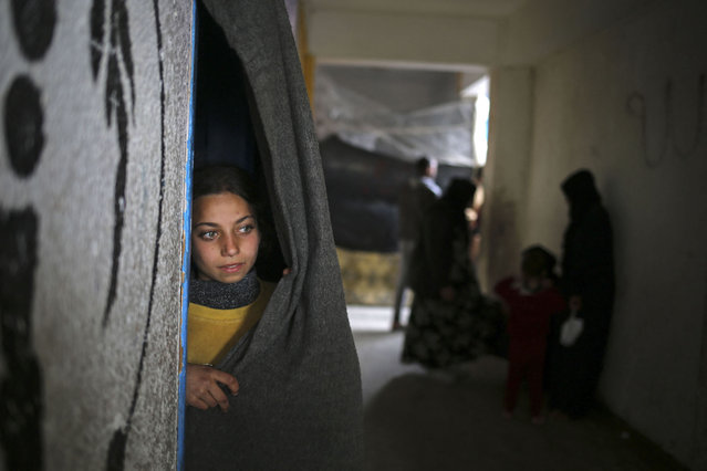 Displaced Palestinians take shelter in a school run by the United Nations Relief and Works Agency for Palestine Refugees (UNRWA), in Rafah in the southern Gaza Strip on March 3, 2024, amid the ongoing conflict between Israel and the Hamas movement. (Photo by AFP Photo/Stringer)