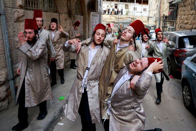 Ultra-Orthodox Jewish men gather as they mark the Jewish holiday of Purim, a celebration of the Jews' salvation from genocide in ancient Persia, in the Mea Shearim neighbourhood of Jerusalem, on March 25, 2024. (Photo by Ammar Awad/Reuters)
