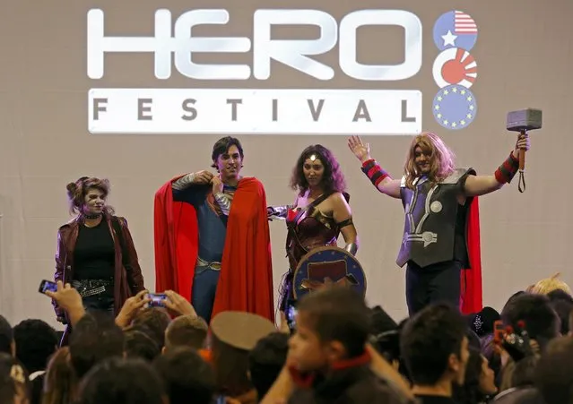 Participants dressed in superhero costumes appear on stage during the first edition of the HeroFestival in Marseille, November 9, 2014. (Photo by Jean-Paul Pelissier/Reuters)