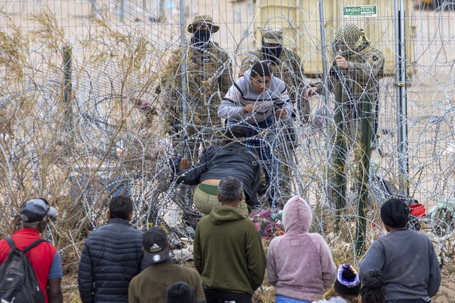 Migrants cross the Rio Grande and navigate barbed wire to reach the Mexico-US border in search of a better life in Ciudad Juarez, Mexico on March 18, 2024. They attempt to surrender to the Border Patrol undetected by the Texas National Guard, as encountering them could mean being returned to Mexico. (Photo by David Peinado/Anadolu via Getty Images)