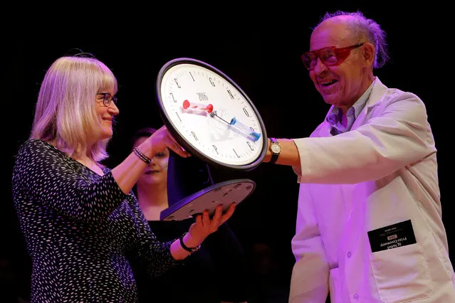 Nobel Laurette Dudley Herschbach (R) presents the 2016 IgNobel Prize in Physics to Susanne Akesson of Sweden for work “discovering why white-haired horses are the most horsefly-proof horses, and for discovering why dragonflies are fatally attracted to black tombstones” during the 26th First Annual Ig Nobel Prize ceremony at Harvard University in Cambridge, Massachusetts, U.S. September 22, 2016. (Photo by Brian Snyder/Reuters)