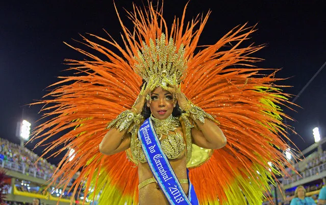 A performer adjusts her costume before the parade of the Imperio Serrano samba school on the first night of Rio's Carnival at the Sambadrome in Rio de Janeiro, Brazil, on February 11, 2018. (Photo by Carl De Souza/AFP Photo)