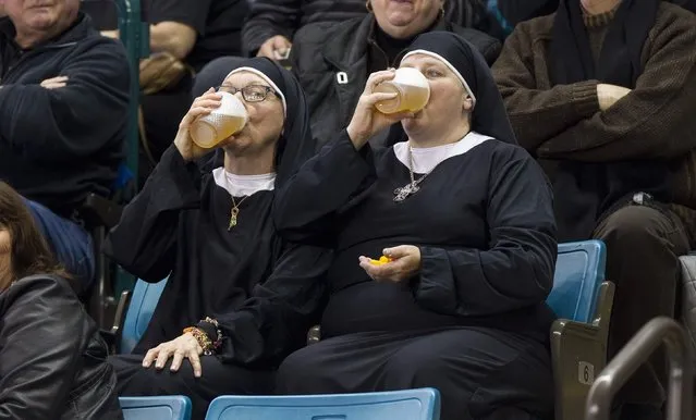 Two women wearing nun outfits drink beer while watching the 2014 Tim Hortons Brier curling championships in Kamloops, British Columbia in this March 8, 2014 file photo. (Photo and caption by Ben Nelms/Reuters)