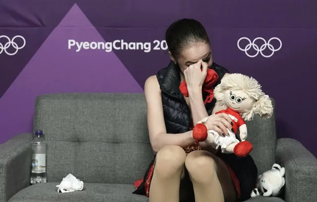 Alina Zagitova of the Olympic Athletes of Russia reacts as realises she has won the gold medal as she watches a television monitor in the green room as compatriot Evgenia Medvedeva wins the silver medal during the women's free figure skating final in the Gangneung Ice Arena at the 2018 Winter Olympics in Gangneung, South Korea, Friday, February 23, 2018. (Photo by David J. Phillip/AP Photo)