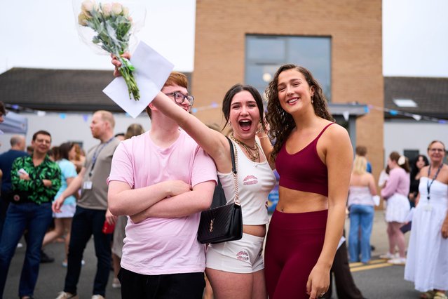 Students at Birkenhead sixth-form college in Wirral, on August 14, 2025 celebrate their A-level results as a record proportion of students in England gained top grades. (Photo by Christopher Thomond/The Guardian)